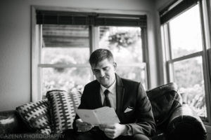 groom emotionally reading letter from bride on wedding day
