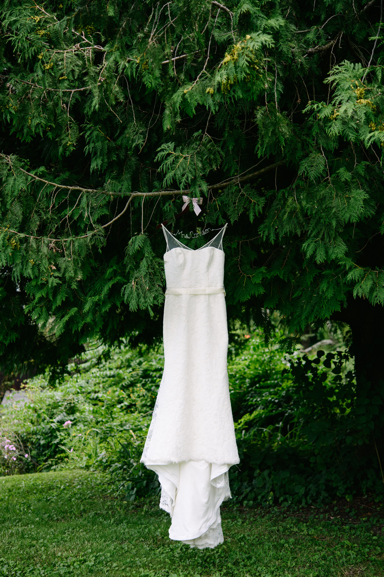 Wedding dress hanging in tree with cute hanger