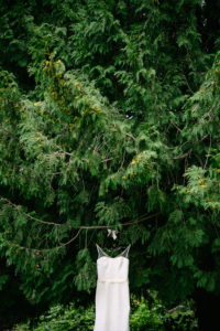Wedding dress hanging in tree with cute hanger