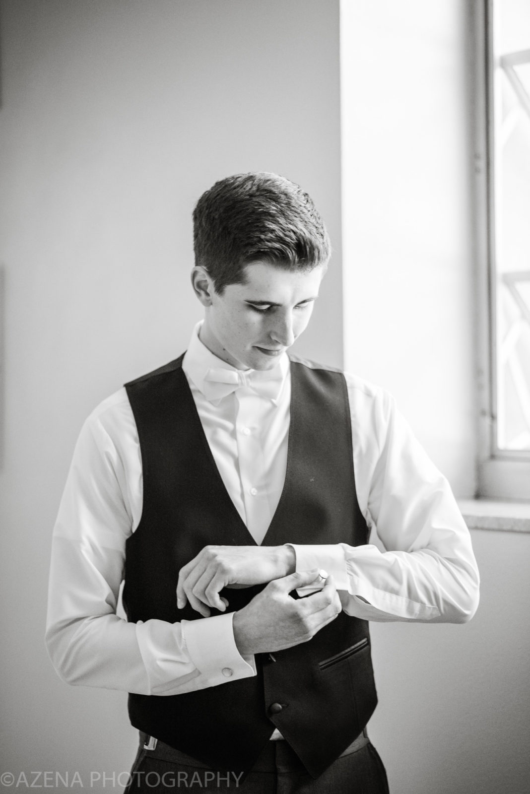 Black and White Photo of Groom putting on cuff links