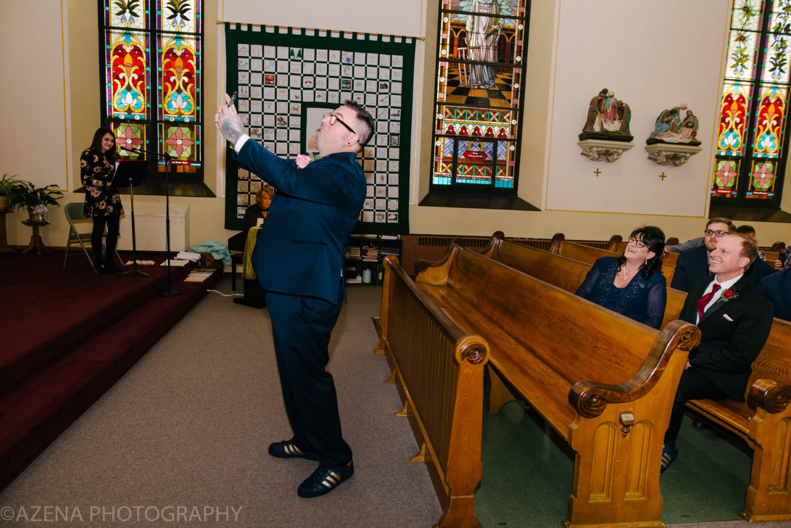 groom taking a selfie at front of church
