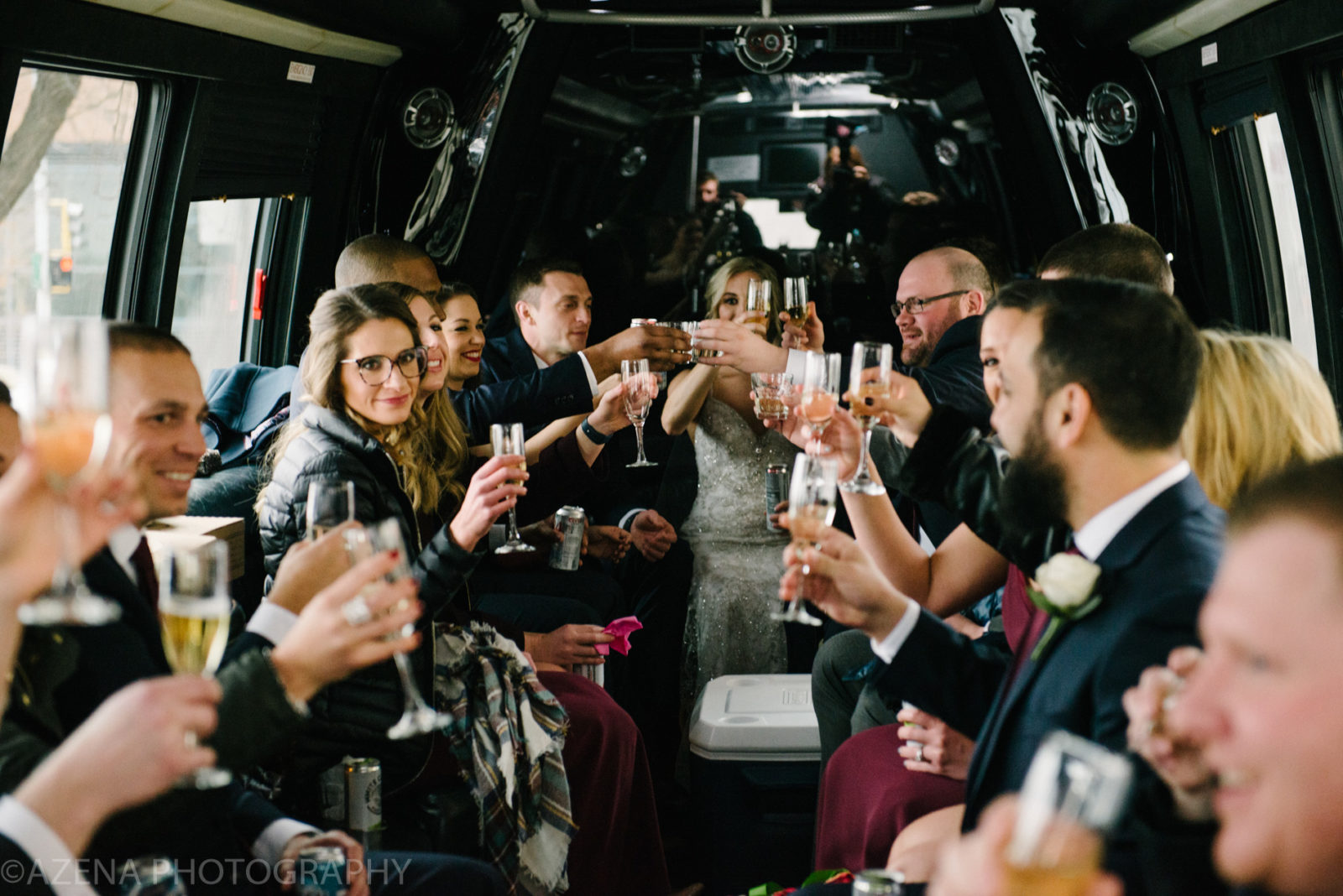 Wedding Party drinking champagne in limo