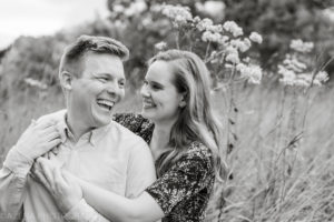 black and white photo of a couple laughing together during engagement session at Owen Conservancy in Madison, WI