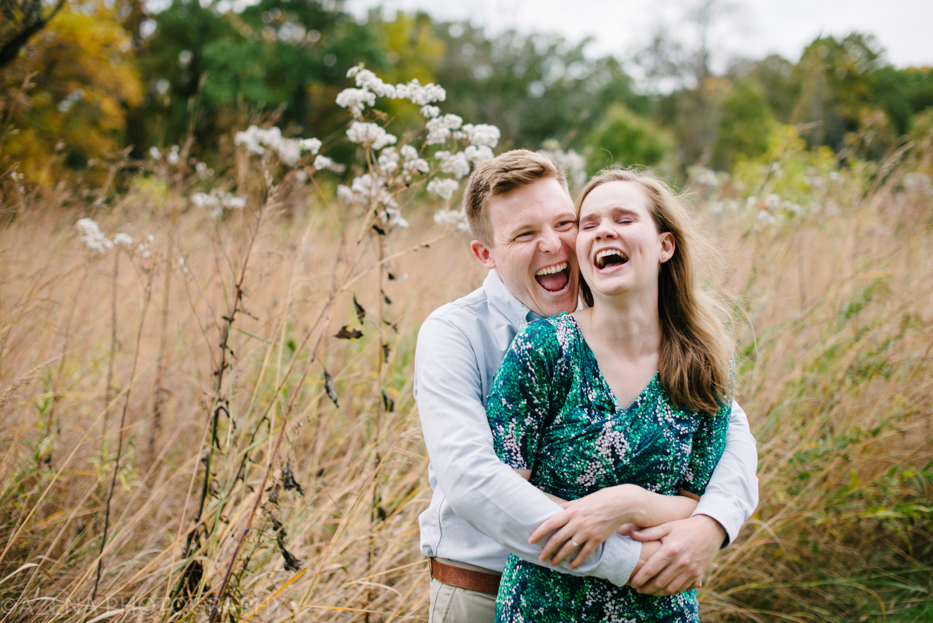 a couple laughing together during engagement session at Owen Conservancy in Madison, WI