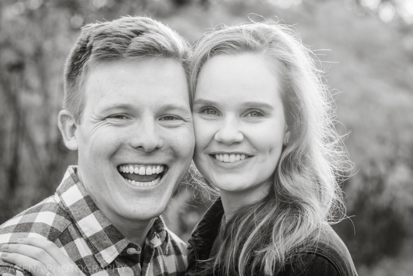 Black and white close up photo of a happy couple smiling
