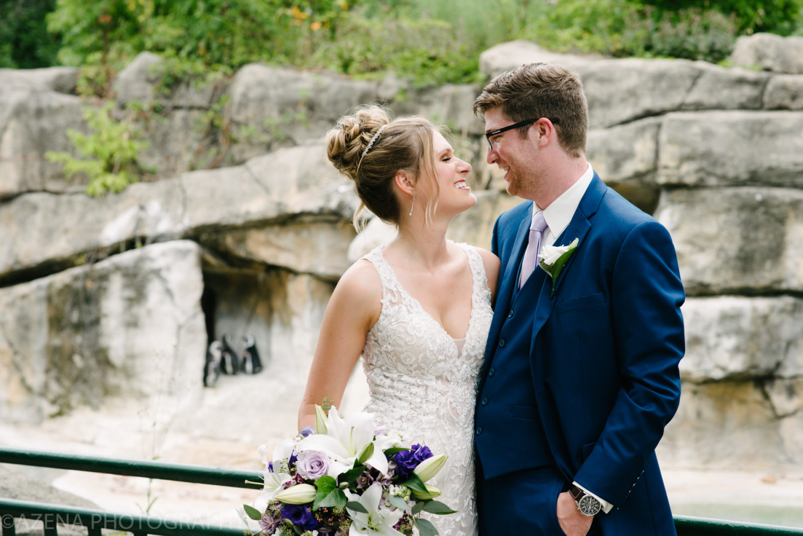 bride and groom at henry vilas zoo with penguins