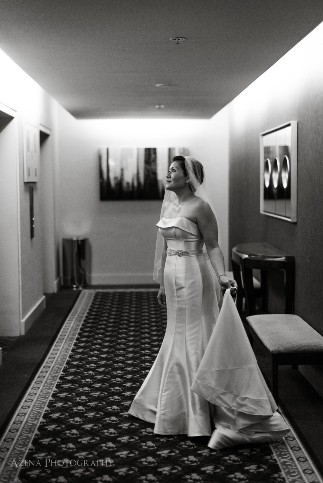 bride waiting for elevator. dramatic black and white photo.
