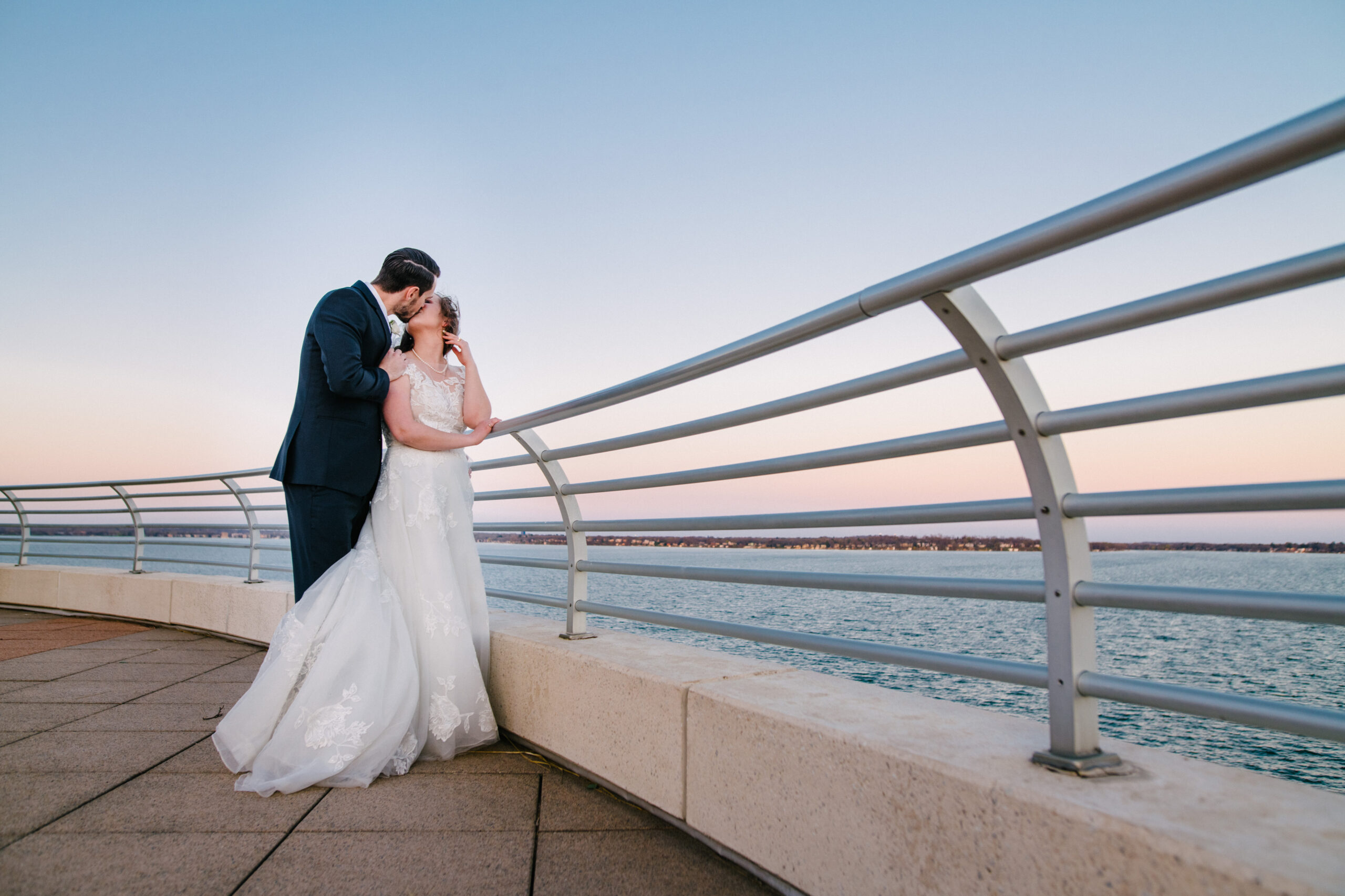 Bride and Groom kissing at sunset on Monona Terrace